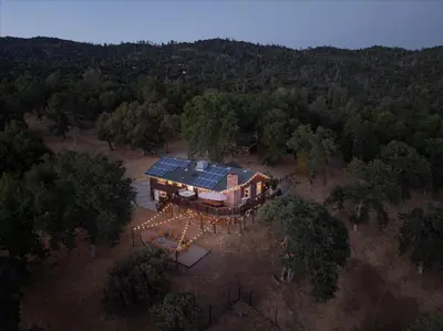 an overhead view of a house with solar panels on it at Yosemite Lookout Lodge w/ hot tub, firepits, game room, and more in Oakhurst