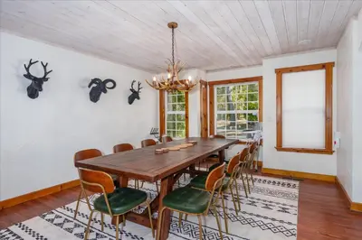 a dining room with a wooden table and chairs at Cedar Creek Lodge with POOL/hot tub/sleeps 24 in Oakhurst