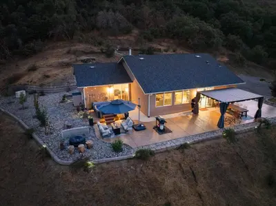 an aerial view of a house with a patio at Hilltop Paradise with stunning views/hot tub/firepit/dog friendly in Oakhurst