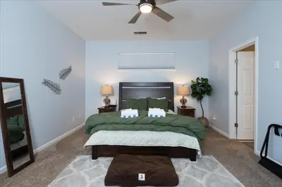 a bedroom with a bed and a ceiling fan at Hilltop Paradise with stunning views/hot tub/firepit/dog friendly in Oakhurst