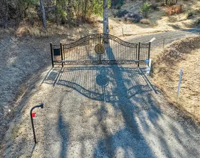 a park bench sitting on the side of a road at Hilltop Paradise with stunning views/hot tub/firepit/dog friendly in Oakhurst