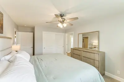 a bedroom with a bed and a ceiling fan at Walk Downtown Remodeled Home in Murphys with Yard! in Murphys