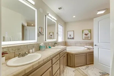 a bathroom with two sinks and a large mirror at Walk Downtown Remodeled Home in Murphys with Yard! in Murphys