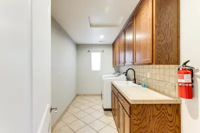 a kitchen with a sink and a washing machine at Walk Downtown Remodeled Home in Murphys with Yard! in Murphys