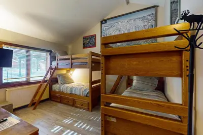 two bunk beds in a room with a desk at Meadow Ridge 44 in Mammoth Lakes
