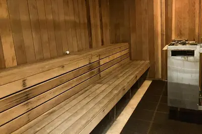 a wooden bench in a room with a stove at Meadow Ridge 44 in Mammoth Lakes