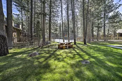 a picnic table in the middle of a yard with trees at Sunshine Village #108- 1 +Loft , Sleeps 6. Steps from Free Town Shuttle ,Dog Friendly in Mammoth Lakes