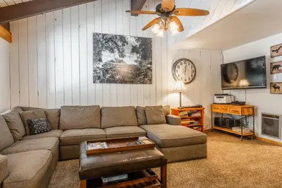 a living room with a couch and a ceiling fan at Sunshine Village #108- 1 +Loft , Sleeps 6. Steps from Free Town Shuttle ,Dog Friendly in Mammoth Lakes