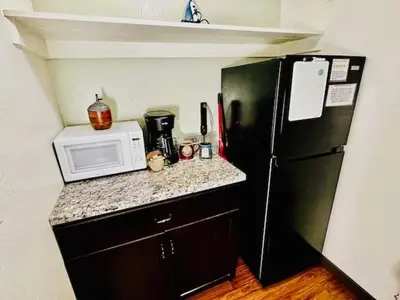 a kitchen with a black refrigerator and a microwave at Treetop Condo in Yosemite-Sleeps 6-Balcony in Yosemite West