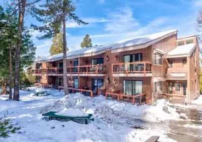 a large wooden building with snow in front of it at Treetop Condo in Yosemite-Sleeps 6-Balcony in Yosemite West