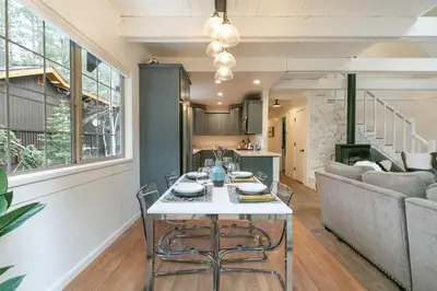 a living room with a table and a couch at Donner Gem by Tahoe Getaways - Beautifully Updated, Hot Tub, Pet Friendly in Truckee