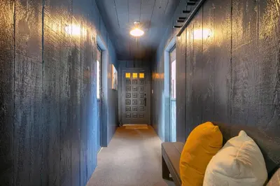 a hallway with a couch and a blue wall at Donner Gem by Tahoe Getaways - Beautifully Updated, Hot Tub, Pet Friendly in Truckee