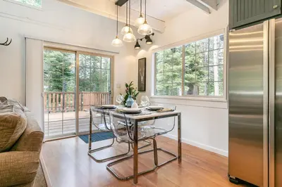 a dining room with a table and a couch at Donner Gem by Tahoe Getaways - Beautifully Updated, Hot Tub, Pet Friendly in Truckee