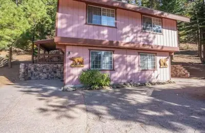 a pink house with a bear on the side of it at Stay in Yosemite-Cozy Bear North-Sleeps 5 in Yosemite West