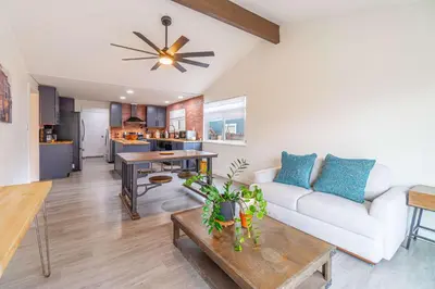 a living room with a white couch and a table at Cozy Family Haven in Sparks - Pet Friendly - Fenced Yard in Sparks
