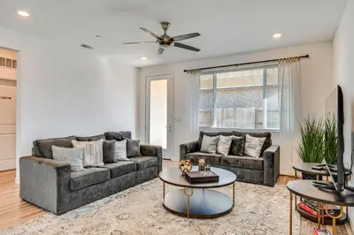 a living room with two couches and a table at 15 Mi to Dtwn Sacramento Newly Built Home! in Sacramento