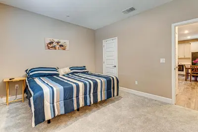 a bedroom with a bed with blue and white sheets at 7 Mi to Folsom Lake Sacramento Area Apartment in Folsom