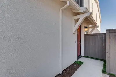 a white house with a red door and a fence at 7 Mi to Folsom Lake Sacramento Area Apartment in Folsom