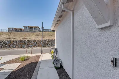 a side view of a white building with a sidewalk at 7 Mi to Folsom Lake Sacramento Area Apartment in Folsom