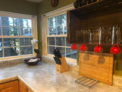 a kitchen with a counter top with a bunch of knives at Cozy Yosemite Cabin with Hot Tub in the Pines in Fish Camp