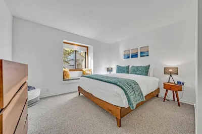 a white bedroom with a bed and a television at Tahoe Retreat with Decks and Separate Studio in Tahoe Vista