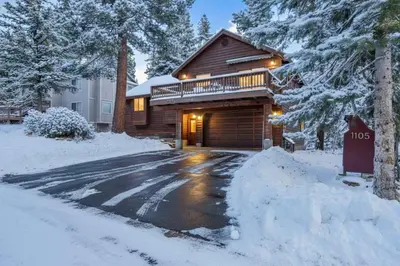 a house with a garage in the snow at Tahoe Retreat with Decks and Separate Studio in Tahoe Vista