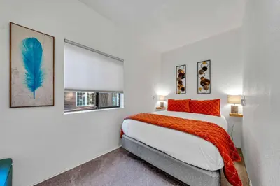 a white bedroom with a bed and a window at Tahoe Retreat with Decks and Separate Studio in Tahoe Vista