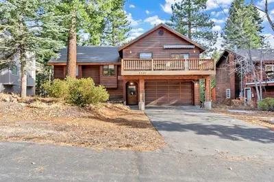 a large wooden house with a garage at Tahoe Retreat with Decks and Separate Studio in Tahoe Vista