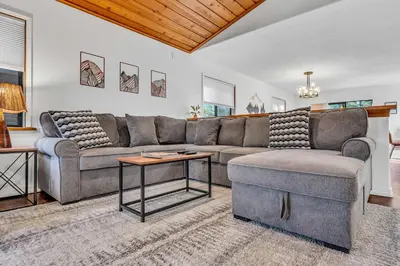 a living room with a couch and a table at Tahoe Retreat with Decks and Separate Studio in Tahoe Vista