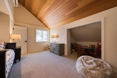 a bedroom with a bed and a table with chairs at Venture in Tahoe Donner by Tahoe Getaways - 4 BR W Hot Tub, Pool Table, Great for Kids! in Truckee