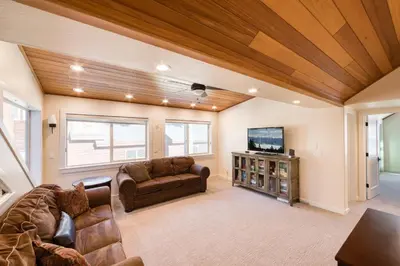 a living room with a couch and a tv at Venture in Tahoe Donner by Tahoe Getaways - 4 BR W Hot Tub, Pool Table, Great for Kids! in Truckee