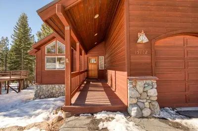 a wooden cabin with a ramp leading to the front door at Venture in Tahoe Donner by Tahoe Getaways - 4 BR W Hot Tub, Pool Table, Great for Kids! in Truckee