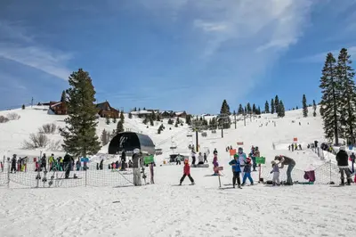 a group of people on a snow covered ski slope at Venture in Tahoe Donner by Tahoe Getaways - 4 BR W Hot Tub, Pool Table, Great for Kids! in Truckee