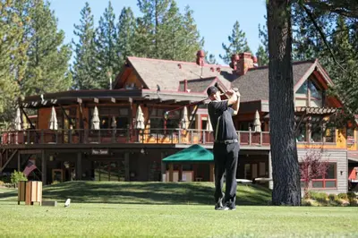 a man swinging a baseball bat in front of a house at Venture in Tahoe Donner by Tahoe Getaways - 4 BR W Hot Tub, Pool Table, Great for Kids! in Truckee