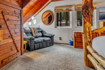 a bedroom with a couch and a bed in a tiny house at Kings Beach Cabin Private Hot Tub, Near Lake & Ski in Kings Beach
