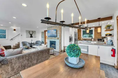 a kitchen and living room with a couch and a table at Cozy Carnelian Bay Vacation Rental with Lake Views in Carnelian Bay
