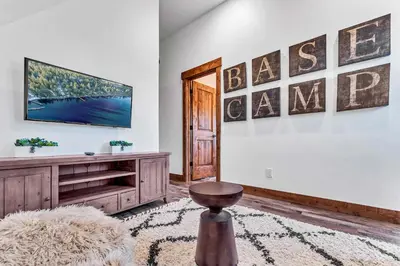 a living room with a television on a wall at Cozy Carnelian Bay Vacation Rental with Lake Views in Carnelian Bay