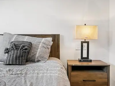 a bedroom with a bed and a lamp on a night stand at Experience the Beauty of Tahoe from Your Zephyr Cove Retreat! #2 in Zephyr Cove