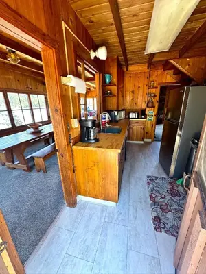 a large kitchen with wooden cabinets and a refrigerator at Wishon Lake Front, Price Reduced, 3day Min in Bass Lake