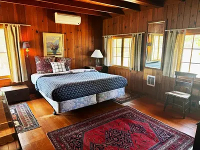 a bedroom with a bed in a room with wooden walls at Wishon Lake Front, Price Reduced, 3day Min in Bass Lake