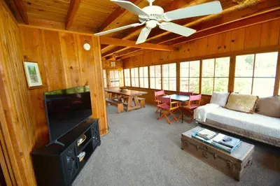 a living room with a couch and a ceiling fan at Wishon Lake Front, Price Reduced, 3day Min in Bass Lake