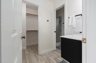 a white bathroom with a sink and a mirror at Luxury Family Villa Sleeps 20 in Coarsegold