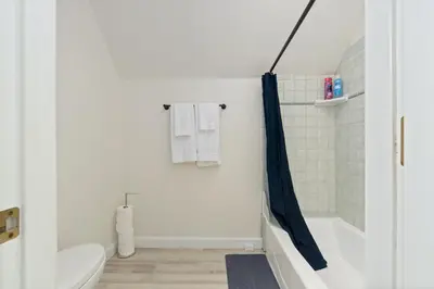 a bathroom with a toilet and a shower curtain at Luxury Family Villa Sleeps 20 in Coarsegold
