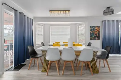 a dining room with a table and chairs at Luxury Family Villa Sleeps 20 in Coarsegold