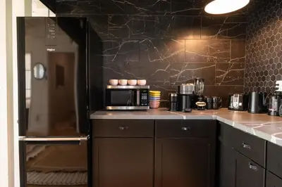 a kitchen with a counter with a microwave and a refrigerator at Rocky Ridge Cabin Yosemite in Coarsegold