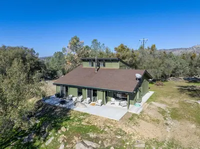 an overhead view of a house with chairs and trees at Rocky Ridge Cabin Yosemite in Coarsegold