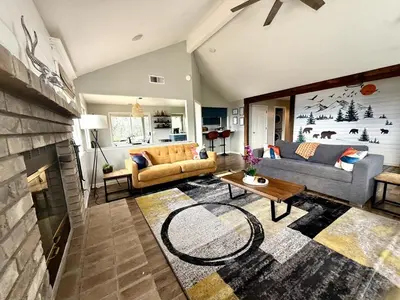 a living room with two couches and a fireplace at Yosemite Vista Highlands in Oakhurst