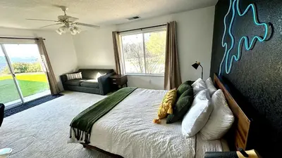 a bedroom with a large bed and a couch at Yosemite Vista Highlands in Oakhurst