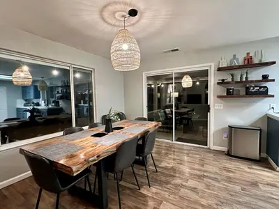a dining room with a wooden table and chairs at Yosemite Vista Highlands in Oakhurst