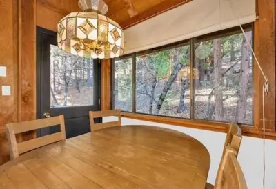 a dining room with a table and a chandelier at Views inside Yosemite-Timber Lodge-Sleeps 6 in Yosemite West